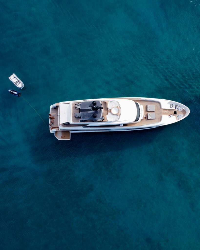 pexels-photo-13386019-13386019 A stunning aerial view of a luxury yacht on the clear waters of Paros, Greece.
