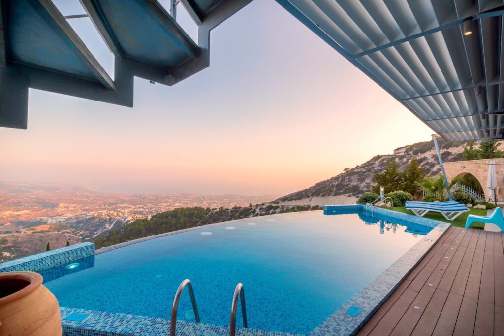 pexels-photo-221457 Infinity pool with breathtaking mountain and city views, perfect for a luxury tropical getaway.