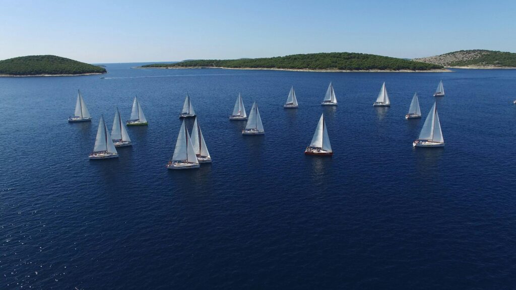 pexels-photo-358326-358326 Sailboats racing in a summer regatta on a clear blue ocean surrounded by islands.