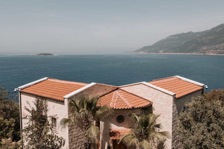 Scenic view of a Mediterranean villa with orange roofs overlooking the Antalya coastline.
